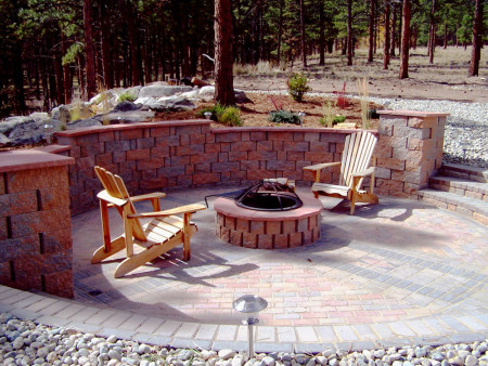 Recessed paver patio and fire pit with paver retaining wall.